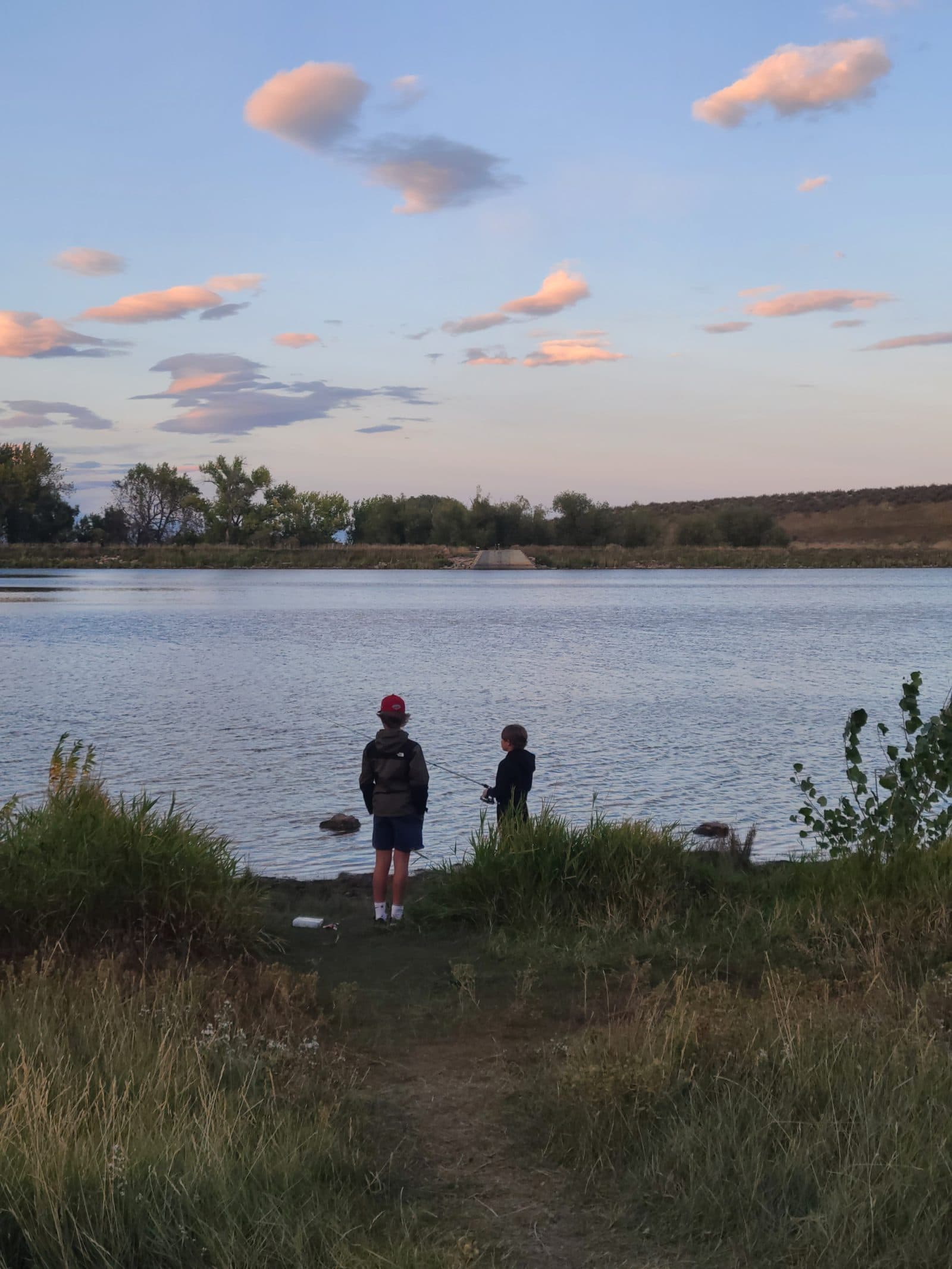 Brothers fishing at a mountain lake.