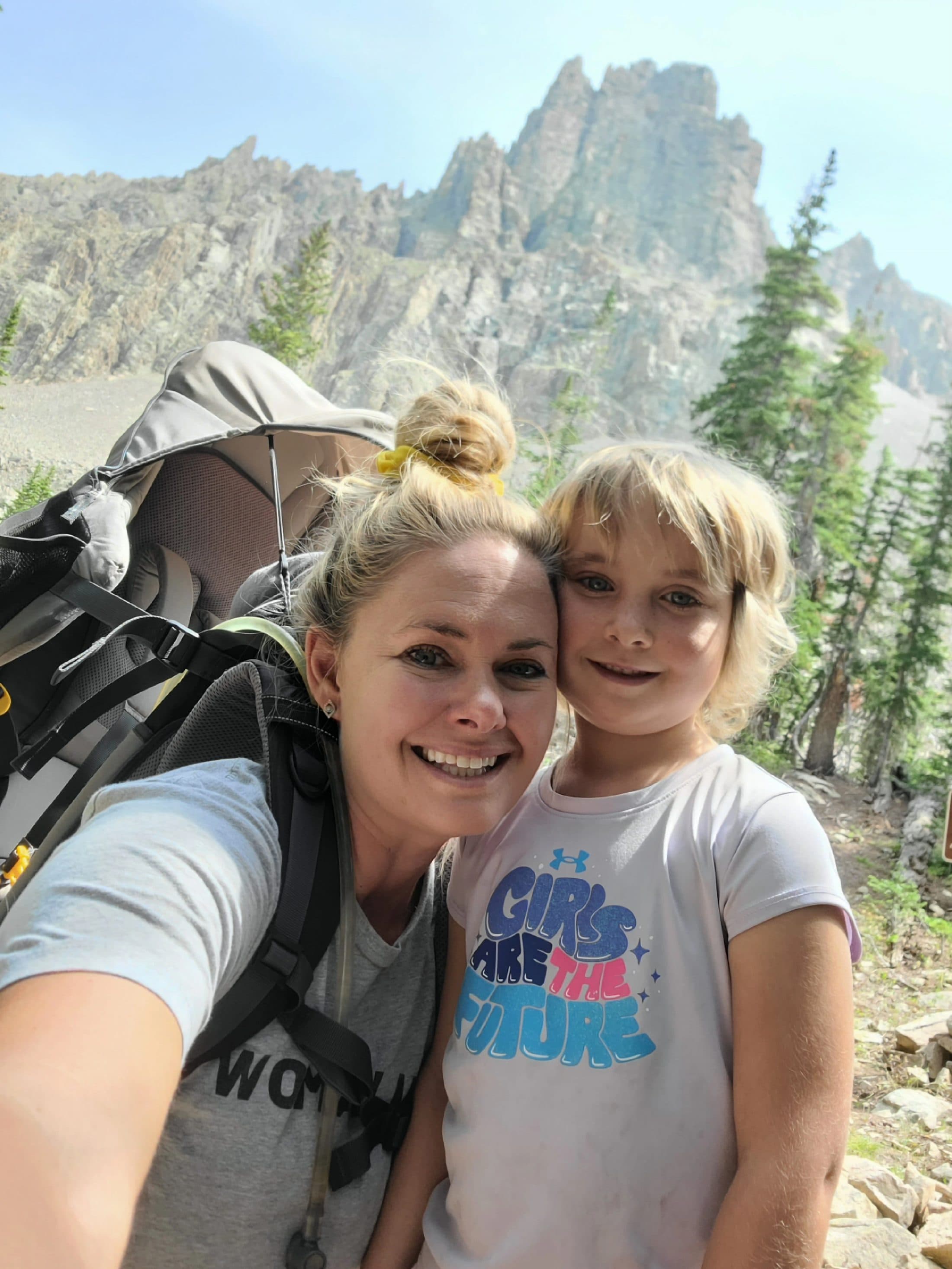 Sarah and Bellamy hiking together, Bellamy riding in the carrier.