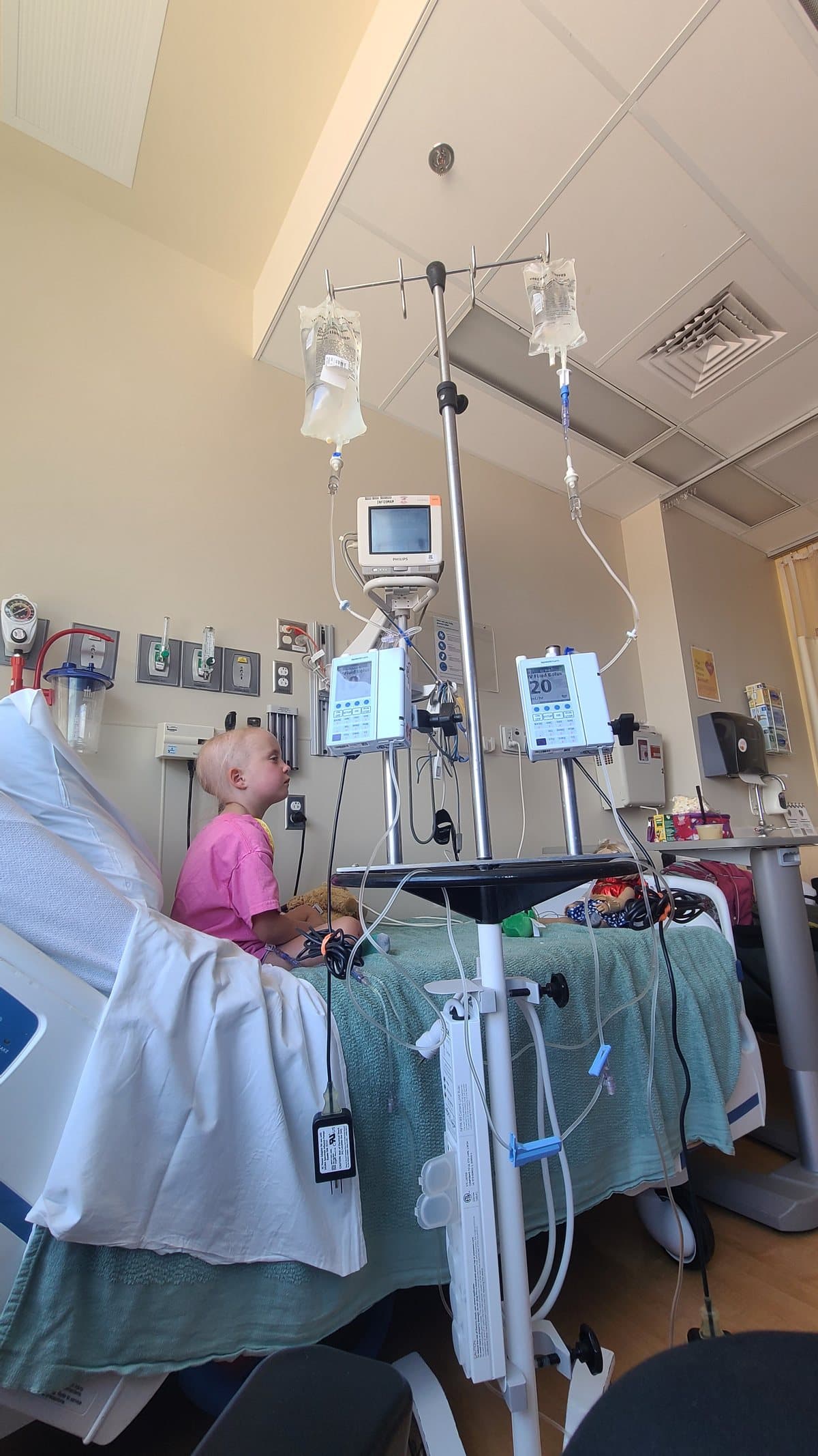 Bellamy in a hospital bed during a transfusion, the room full of machines.