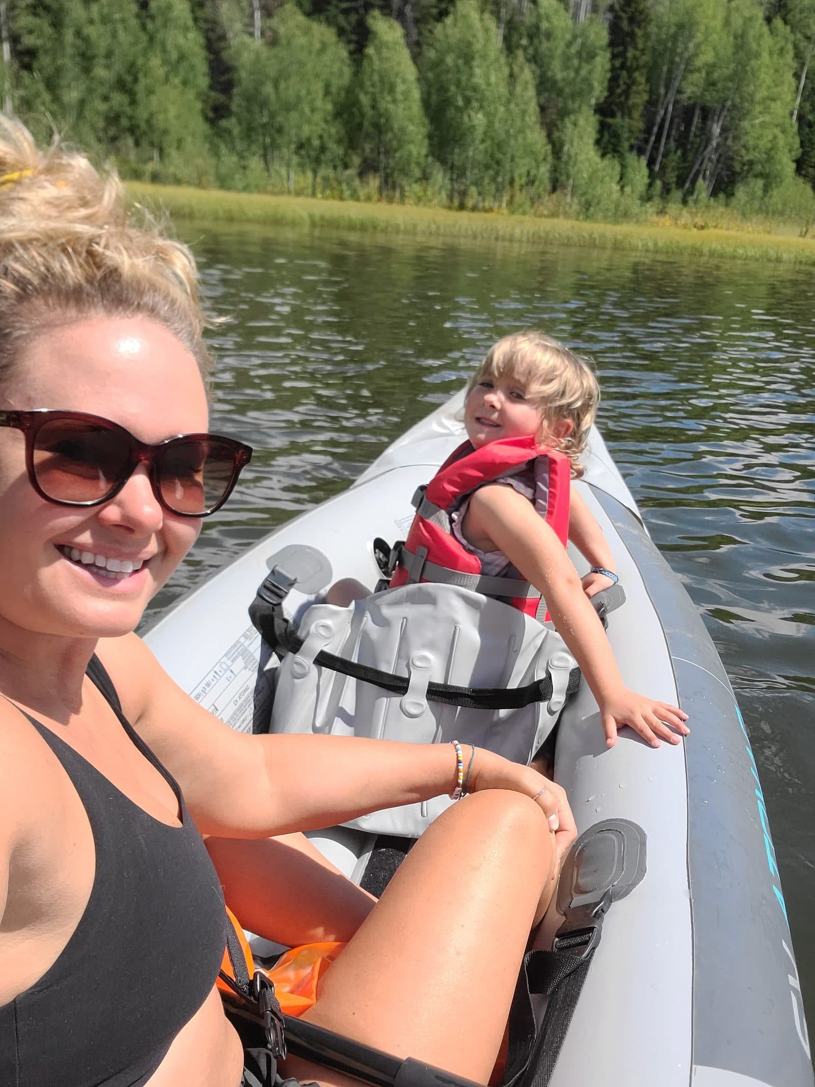 Sarah and Bellamy out on a lake in a kayak.
